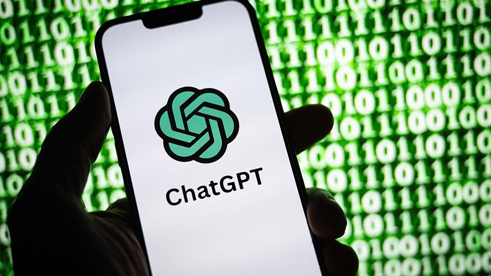 ChatGPT logo on a phone in front of a screen showing zeros and ones