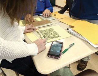 Portsmouth High School students put together QR codes that will give them hints to their geometry proof.