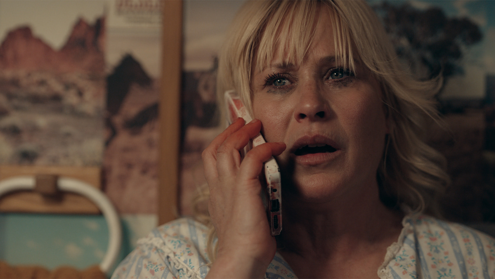 Peggy Newman looks shocked as she takes a phone call in High Desert on Apple TV Plus