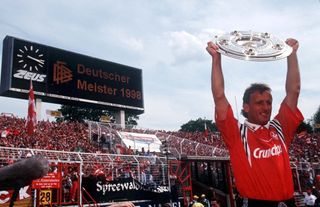 Andreas Brehme holds the Bundesliga trophy aloft after Kaiserslautern's title triumph in 1998.