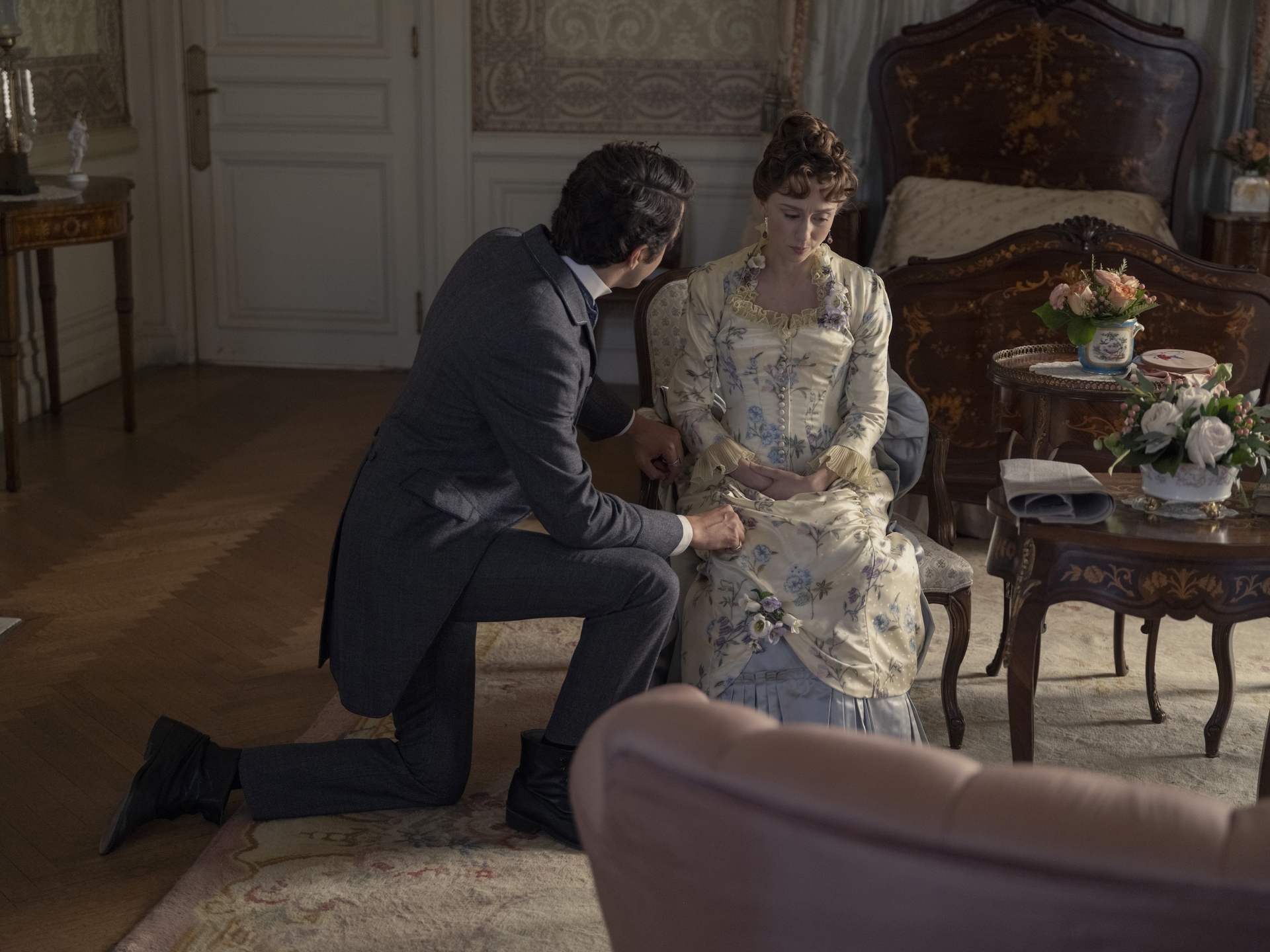 harry richardson as larry kneeling while talking to taissa farmiga as gladys in a still from the gilded age season 3