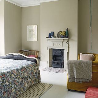 guest room with fireplace and floral bedspread