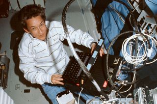 Astronaut Mary Cleave is seen on the mid-deck of the space shuttle Atlantis using a laptop computer to run a fluid experiment apparatus during the STS-30 mission in May 1989.