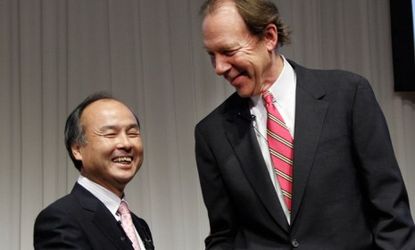 Softbank CEO, Masayoshi Son (left) and Chief Executive of Sprint Nextel Corp., Dan Hesse shake hands during their press conference in Tokyo, on Oct. 15.