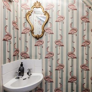 downstairs toilet with Hackney flamingo wallpaper and white wash basin and mirror