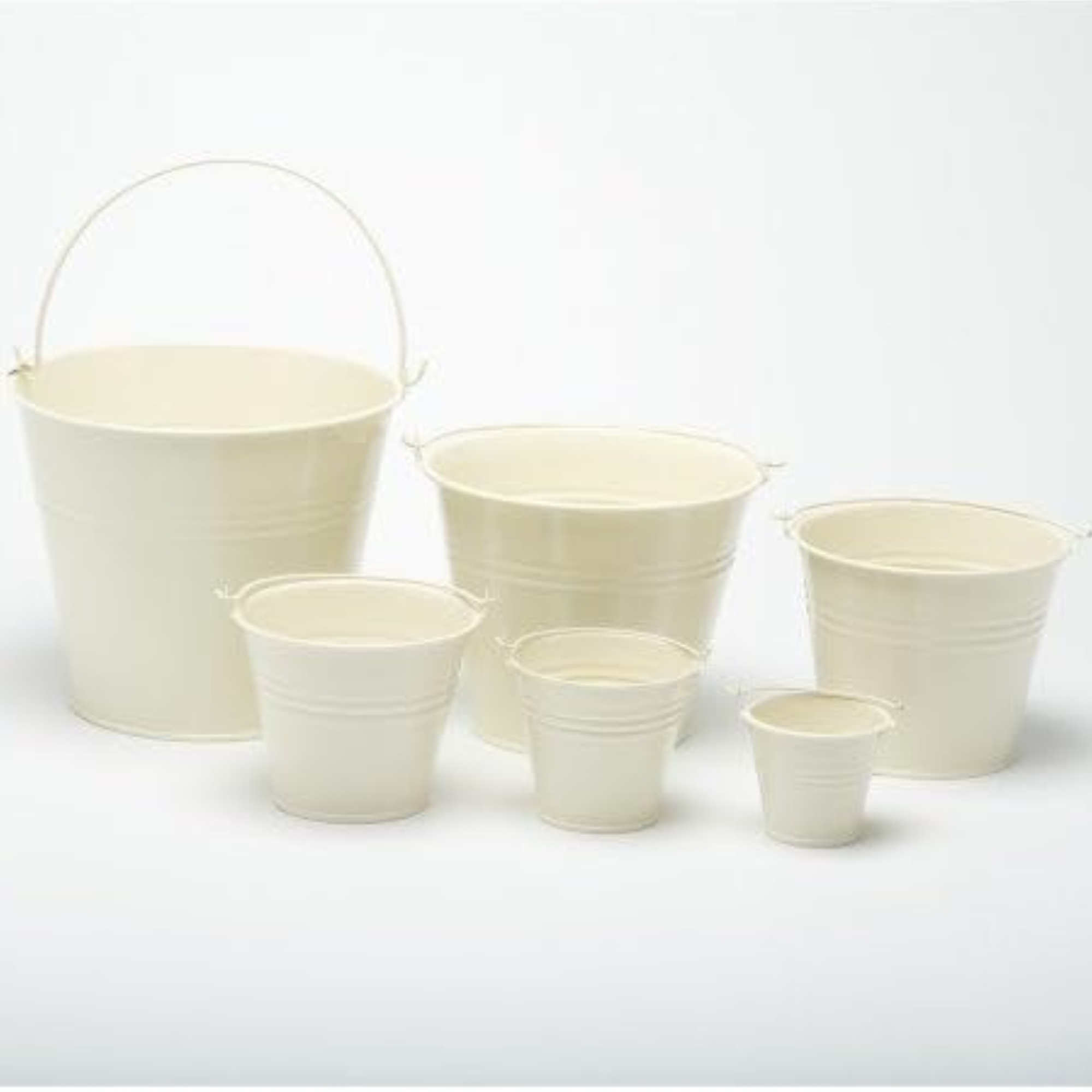 Metal buckets coated in cream paint for the garden