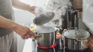 Cooking in the kitchen and releasing steam from a pan