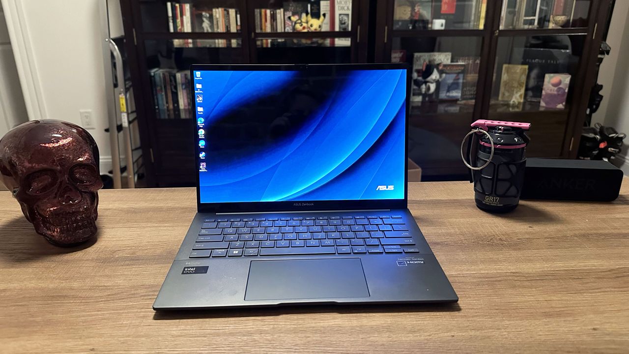 Asus Zenbook 14 OLED (Q425M) open facing camera on a wooden desk