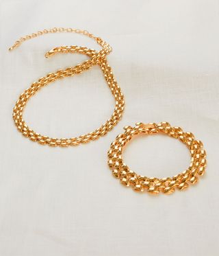 Gold chunky chains against white background