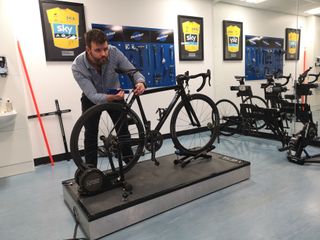 Image shows Phil Burt adjusting a bike saddle in a bike fit.