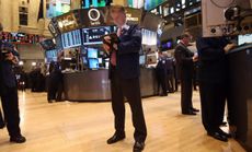 A stock trader works the floor of the New York Stock Exchange on April 23.