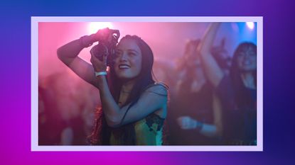 Is City on Fire based on a true story? Pictured: Chase Sui Wonders as Sam Yeung in City on Fire on Apple TV+ she's taking photos at a concert