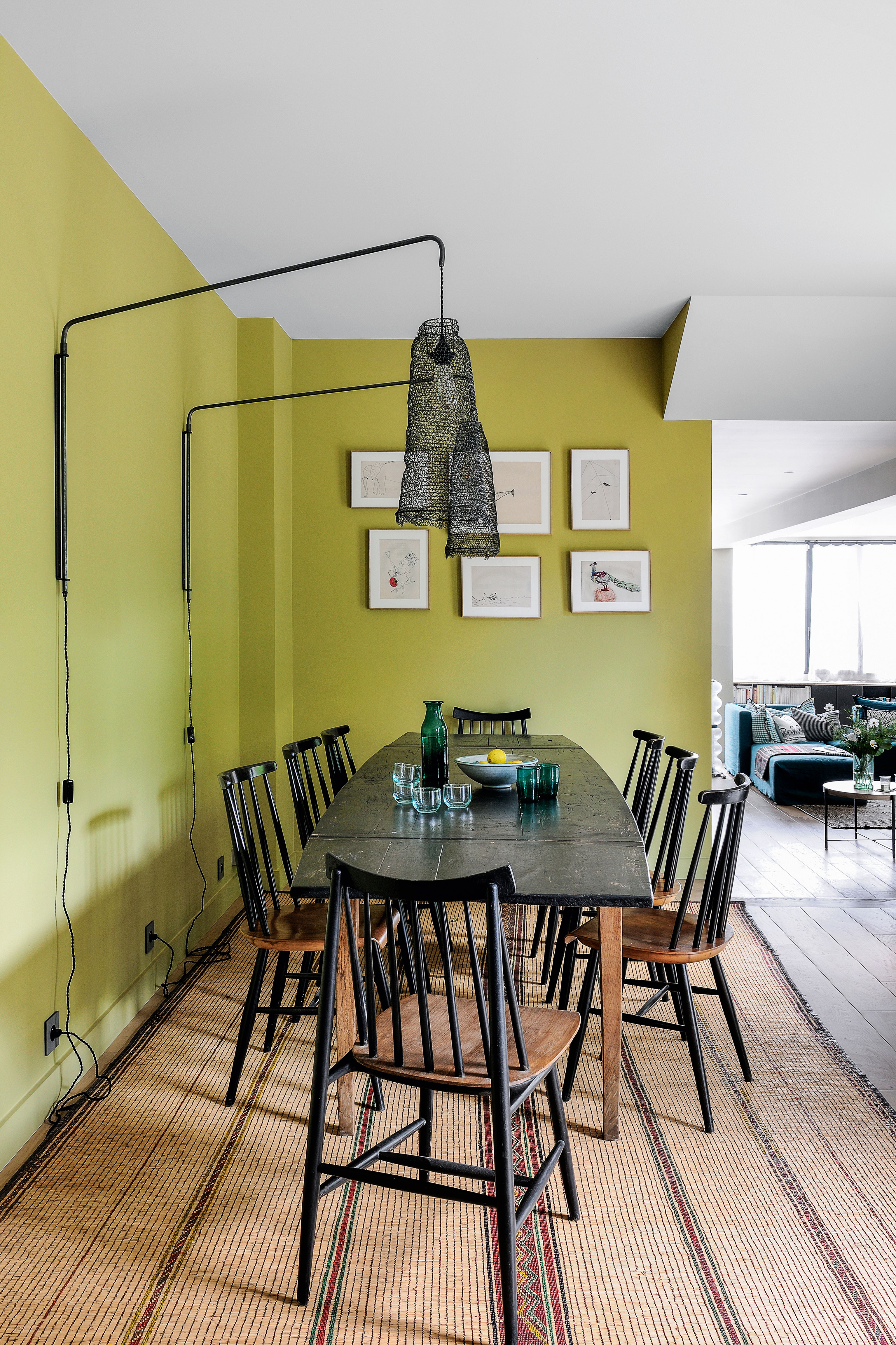 Lime green dining room with statement black net wall lights