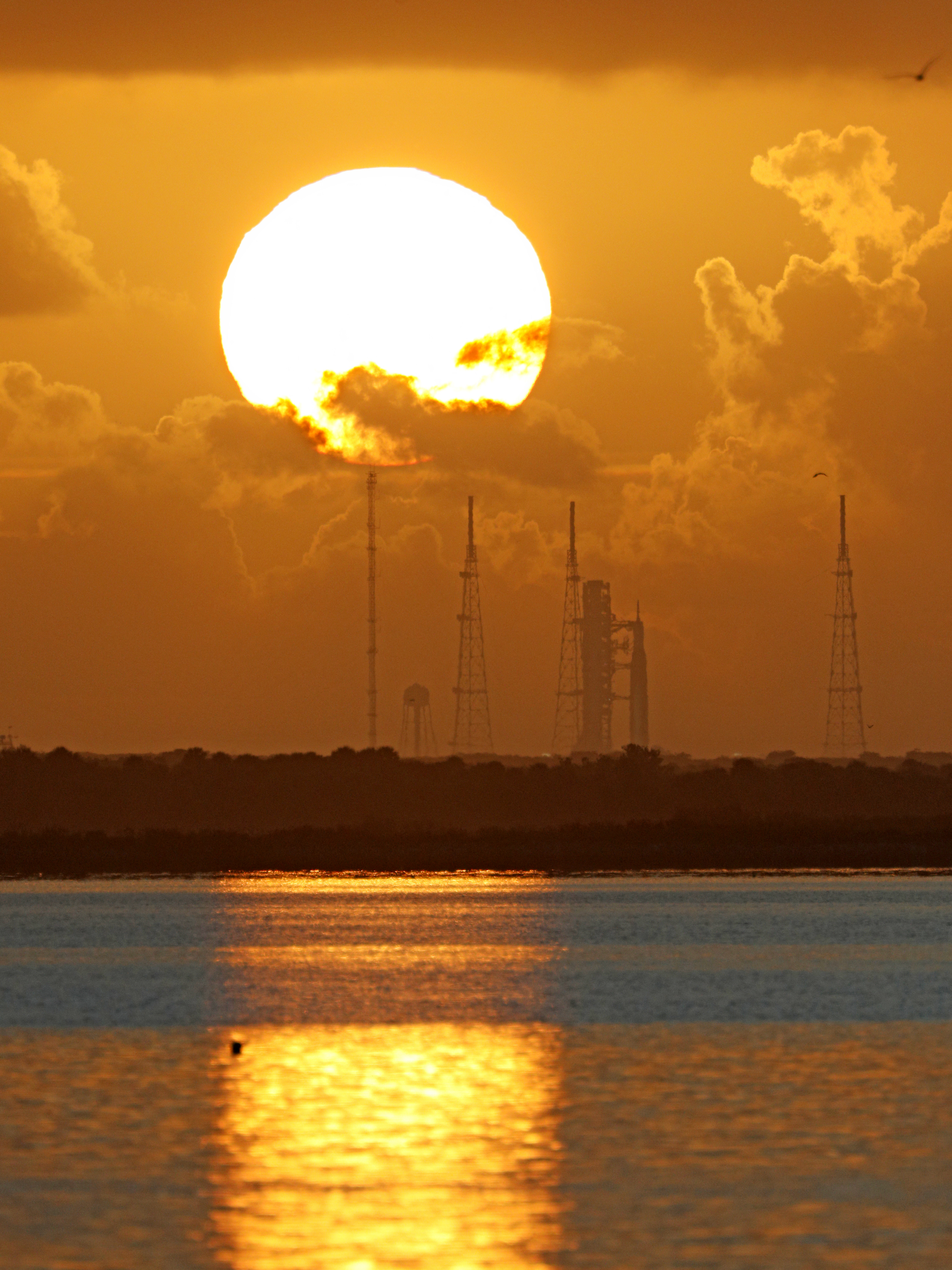 The Artemis II rocket stands at sunrise.