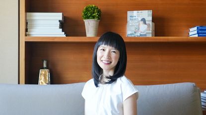 marie kondo with shelves behind her