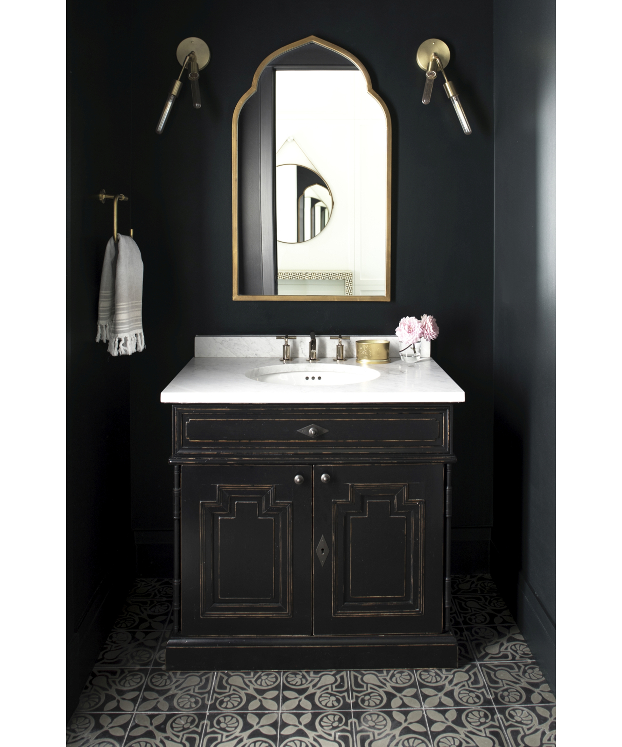 Black bathroom scheme with monochrome floor tiles and mirror by Benjamin Moore