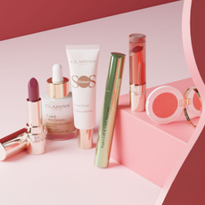 Clarins make up products on a pink background