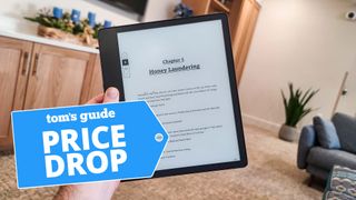 Amazon Kindle Scribe held in front of living room