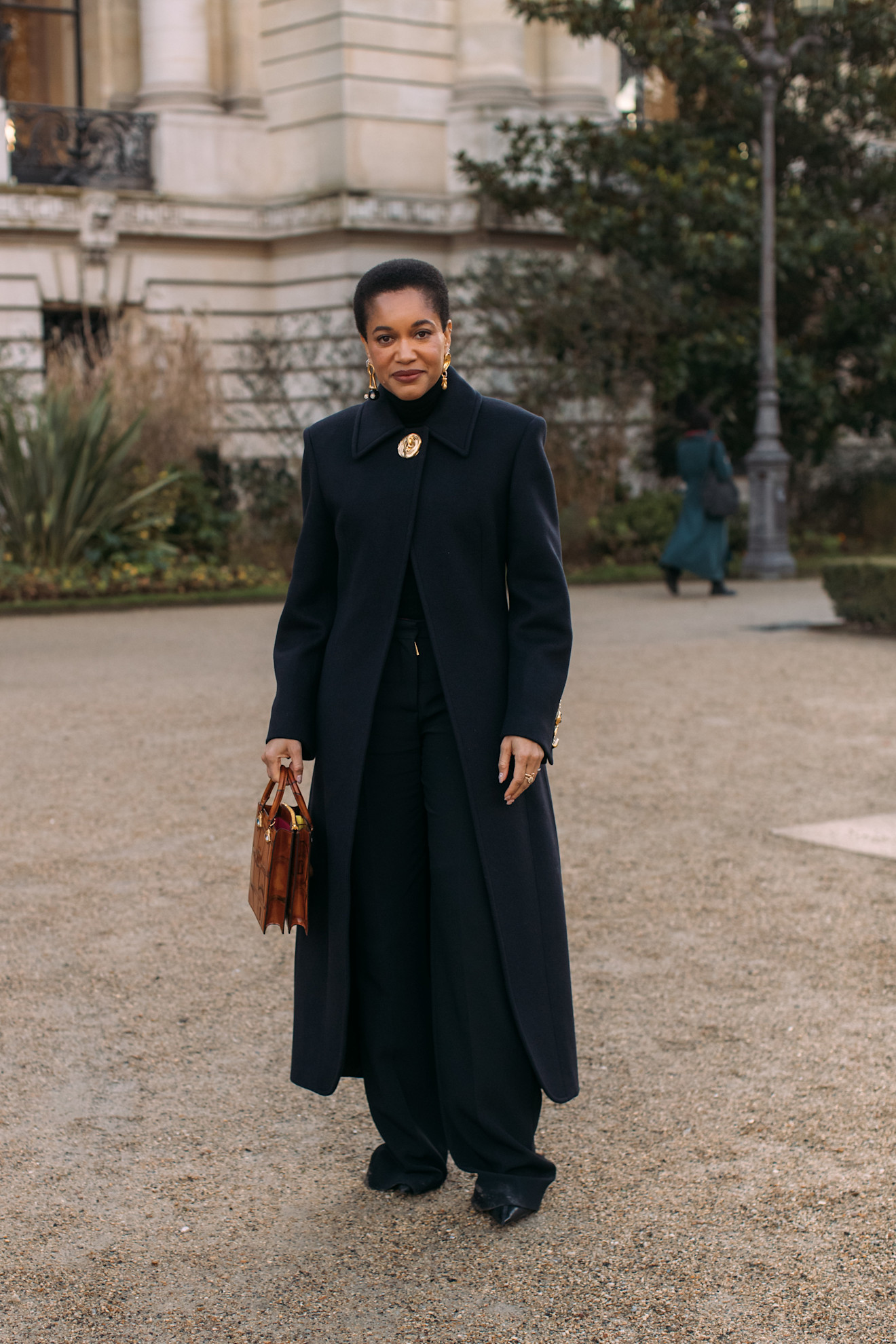 woman wearing black coat and pants