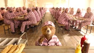 Paddington wearing a pink jumpsuit while in prison during the comedy movie, Paddington 2.