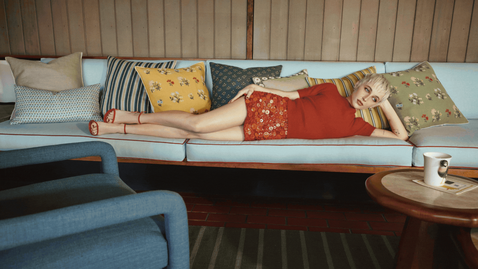GIF of three press images showcasing the West Elm x Emma Chamberlain collaboration. There are images of Emma in trendy, primary colored outfits, lounging amongst the mid-century-inspired furniture 