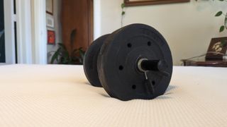 Testing the pressure relief of the Essentia Stratami Organic mattress using a dumbbell