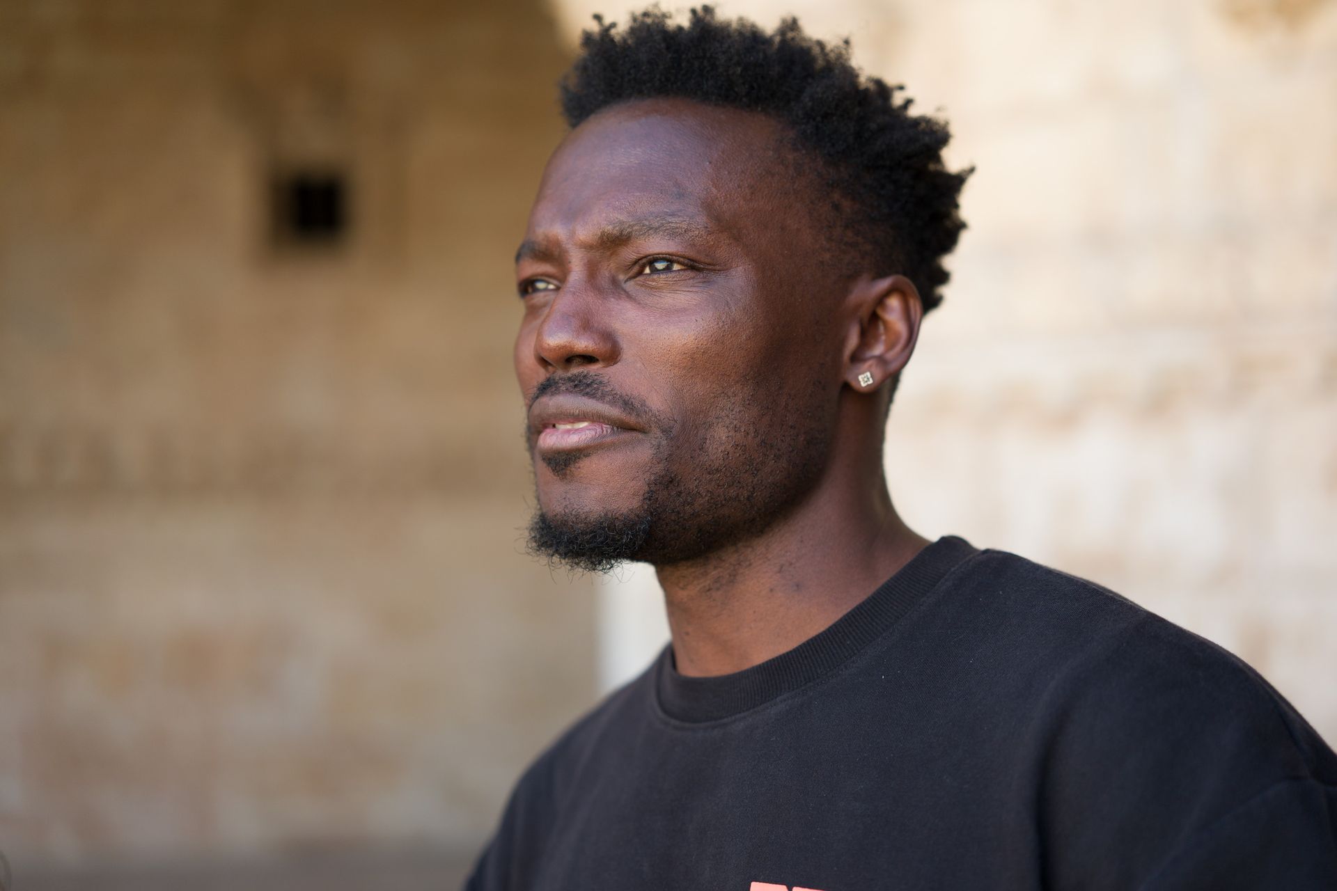  portait of a man in a black t short
