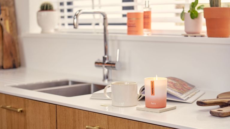 scented candle on kitchen counter with sink