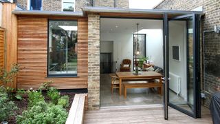 Cheap extension ideas: panelled extension with large bifold glass doors by IQ glass