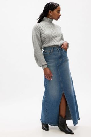 grey jumpers woman wearing light grey cable knit turtleneck with maxi denim skirt and boots