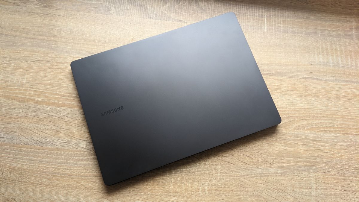 The Samsung Galaxy Book3 Pro 14-inch laptop pictured atop a wooden desk.