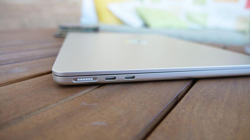 MacBook Air 13 M3 closed on a slatted wooden table showing the ports and overall thinness