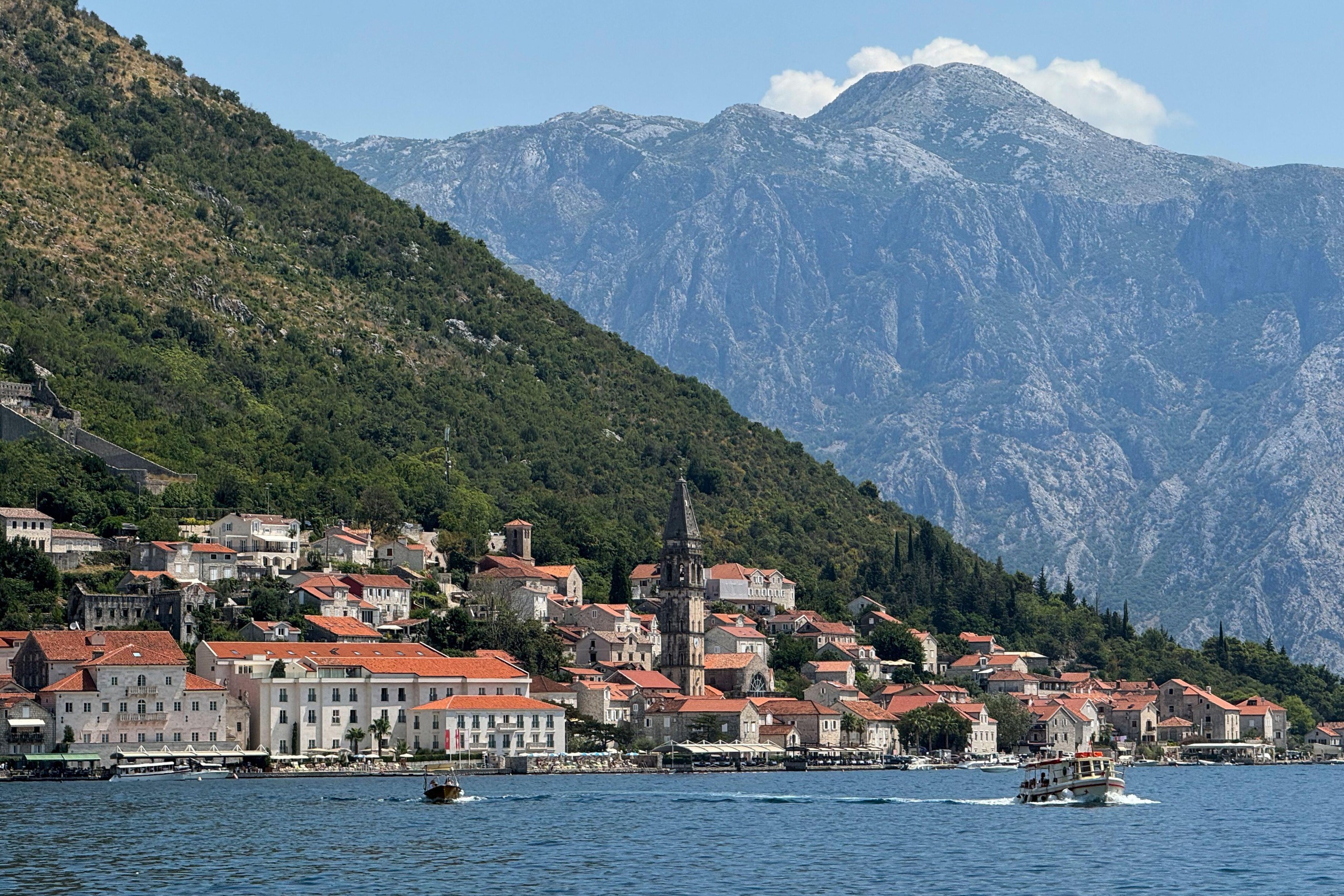A waterside town in Montenegro, with soaring mountains behind