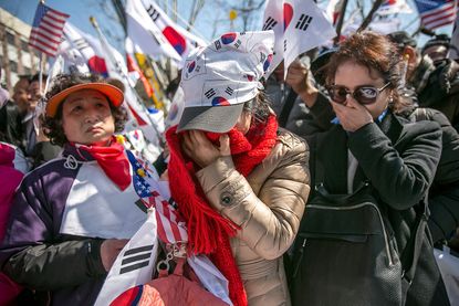 Supporters of President Park Geun-hye cry when she is impeached