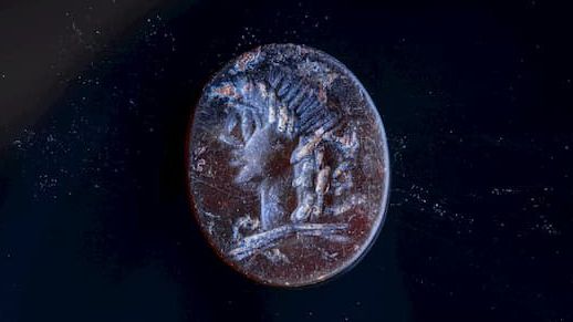 The detailed carving of Apollo is smaller than a dime.