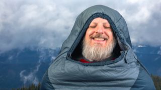 how to choose a sleeping bag: happy sleeping bag man