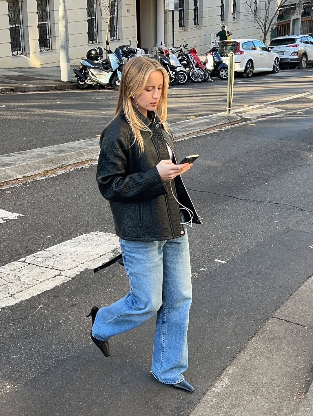 woman wearing black pointed toe heels jeans fall outfits 2025