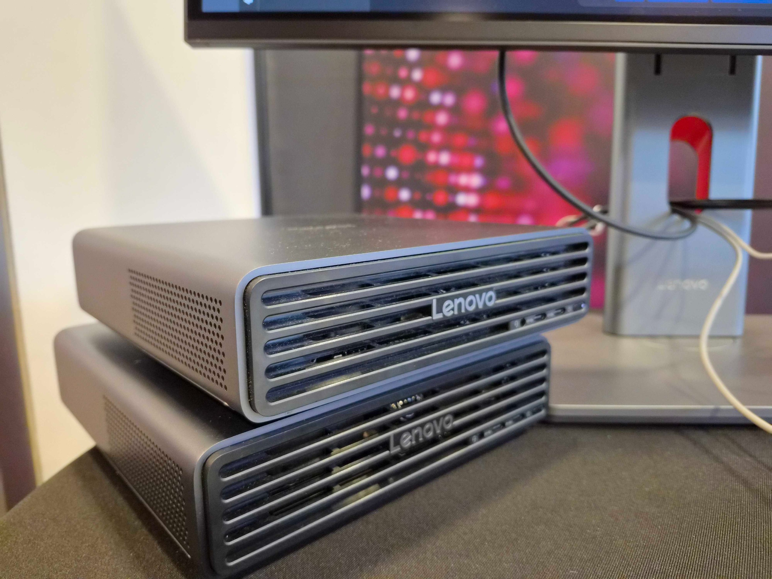 The Lenovo ThinkCentre X Ultra desktop pictured on a desk beneath a PC monitor at Lenovo Innovation World 2026.