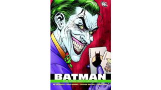 The cover of The Man Who Laughs with The Joker smiling and holding playing cards.