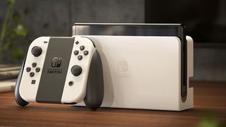 A product shot of the white nintendo Switch OLED on a wooden desk