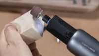 The Hoto Cordless Rotary Toolkit grinding on a piece of wood