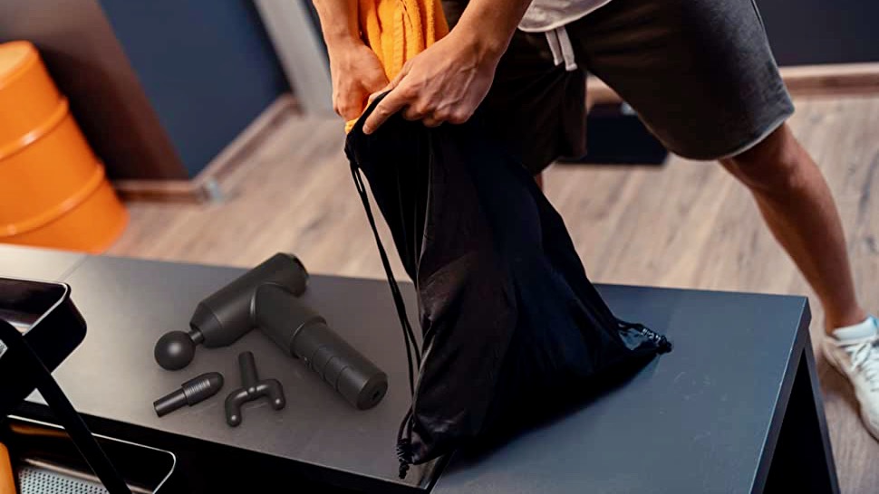 HoMedics Physio Massage-Pistole auf eine Bank im Gym