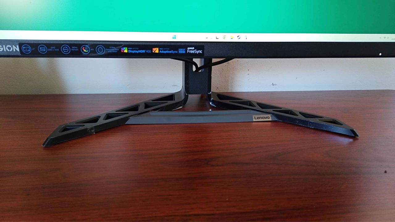 Close up of Lenovo Legion R27qe monitor V-shaped stand on desk.