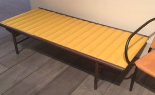 Low day bed with dark wooden frame