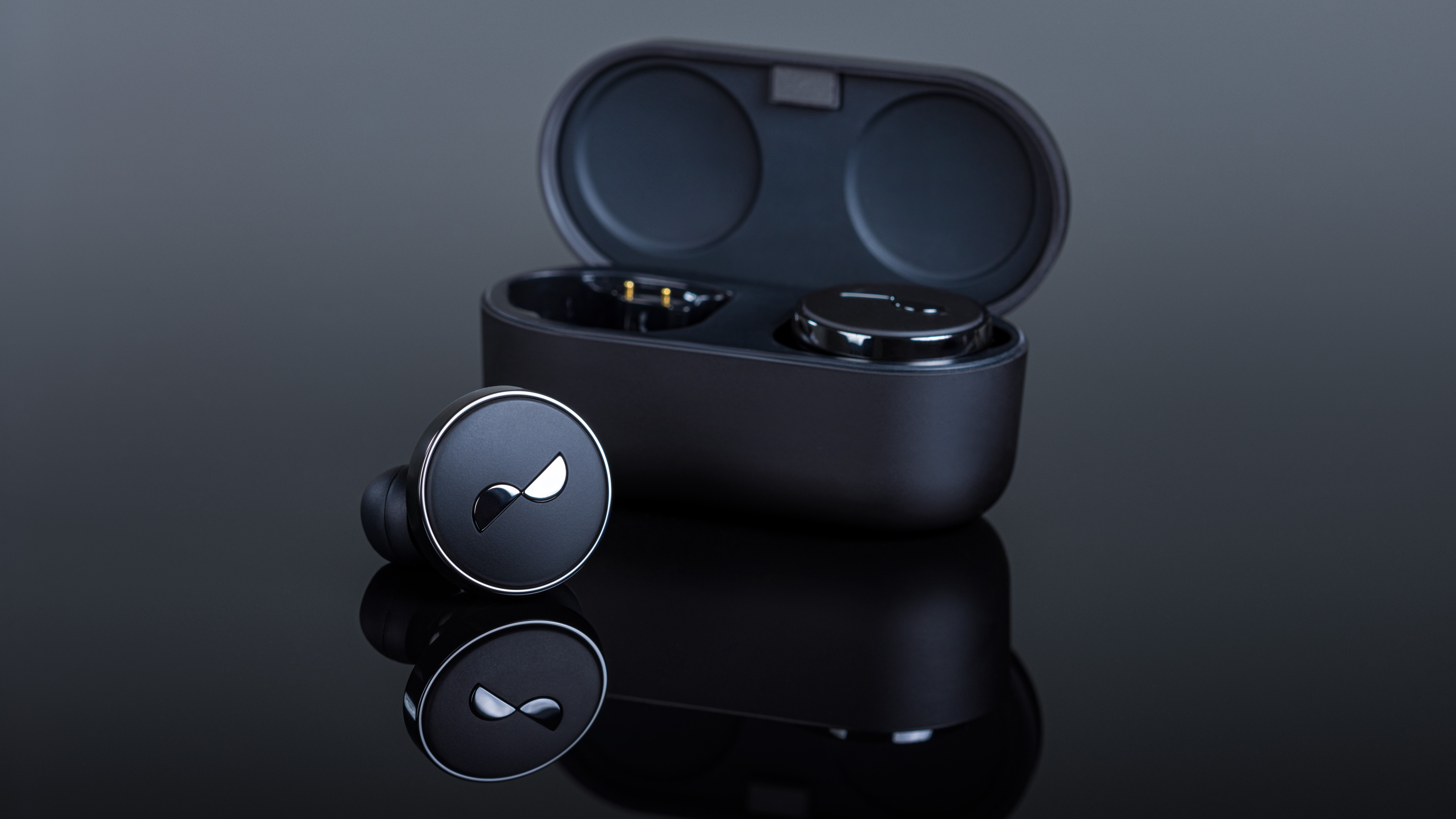 NuraTrue Pro Earphones with Charging Case Open on a Highly Reflective Black Surface