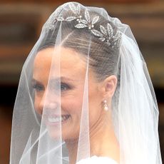 Olivia Henson on her wedding day wearing a fabrege diamond tiara drop earrings and an updo inspired by Kate Middleton