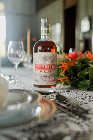 Don Papa rum on table with lace tablecloth