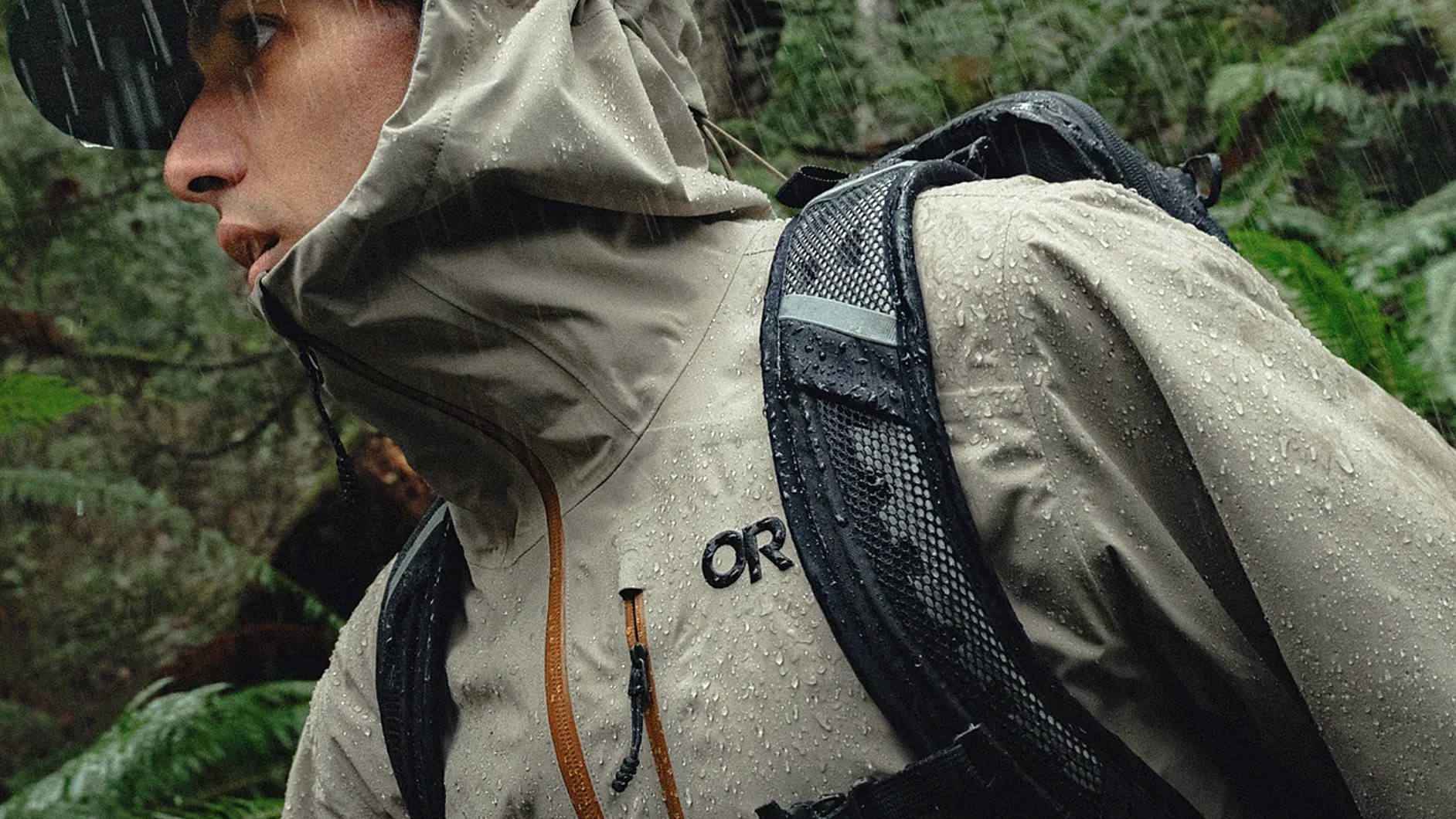 Close-up of a hiker wearing the Outdoor Research Foray 3L jacket during a rainy trek