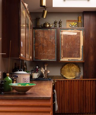Kitchen by Retrouvius made from a selection of salvaged wood with brass kick plates
