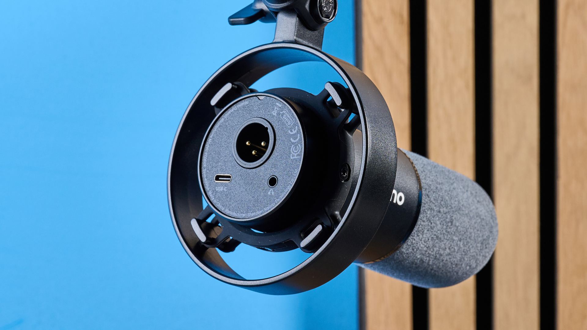 the maono pd1300x microphone for podcasting with an xlr and usbc connection and a boom arm in the photograph but also available with a desktop stand, one button dial on the mic and a muting button